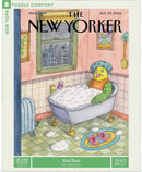 A whimsical jigsaw puzzle titled 'Bird Bath' featuring a colorful cartoon illustration by Roz Chast. The scene shows a bird character lounging in a bubble-filled bathtub, surrounded by soap bubbles and playful decor in a bathroom setting. It highlights vibrant colors and humorous details, inviting puzzlers to enjoy a fun and creative experience.