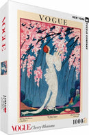 Cherry Blossoms jigsaw puzzle by New York Puzzle Company featuring a vibrant illustration from Vogue magazine, depicting a lady in elegant attire surrounded by blooming cherry trees. The puzzle contains 1000 pieces, ideal for puzzle enthusiasts and art lovers alike.