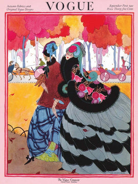 A colorful jigsaw puzzle featuring two fashionable women in autumn attire. The background is filled with vibrant trees in shades of red and yellow, capturing the essence of fall. The women are wearing stylish outfits with large hats and flowing skirts, set against a whimsical landscape that includes carriages and birds.