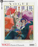 A picturesque jigsaw puzzle titled 'Painted Parasols' by New York Puzzle Company, featuring a vintage Vogue cover illustration from March 15, 1924. The artwork depicts elegantly dressed women holding colorful, decorated parasols in a vibrant spring scene, showcasing intricate details and a nostalgic charm. Perfect for puzzle enthusiasts and art lovers alike.