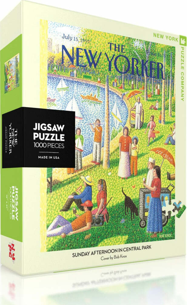 A vibrant jigsaw puzzle box featuring the artwork 'Sunday Afternoon in Central Park' by Bob Knox. The cover showcases a lively scene in Central Park, depicting people enjoying a sunny day by the lake, surrounded by greenery and boats. The packaging states it contains 1000 pieces and is made by the New York Puzzle Company. The design captures the essence of a warm summer weekend in the city, ideal for puzzle enthusiasts.