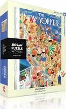 The Beachgoing jigsaw puzzle by New York Puzzle Company features a vibrant illustration from The New Yorker, depicting a lively beach scene filled with people enjoying the sun, colorful beach umbrellas, and a snack stand with ice cream cones. The puzzle includes 1000 pieces and showcases unique artwork by Richard Taylor.