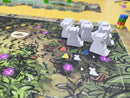 A zoomed in photo of the game board, featuring axolotl-shaped wooden pieces/