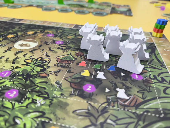 A zoomed in photo of the game board, featuring axolotl-shaped wooden pieces/