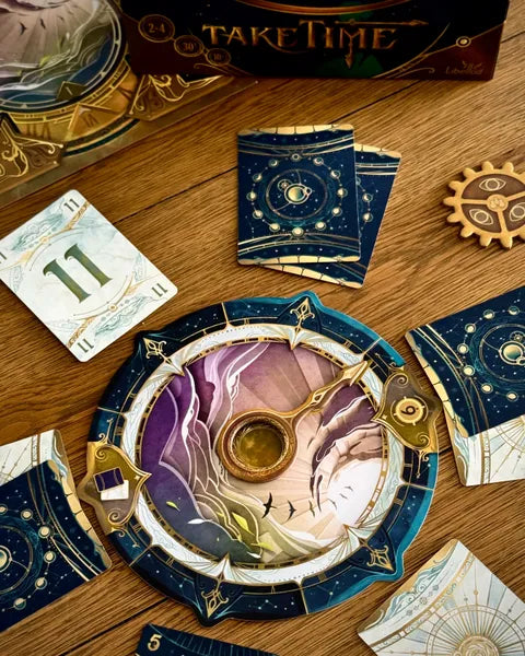 Decorative cards with starry design on a wooden surface, featuring the game pieces found in the box for 'Take Time'.