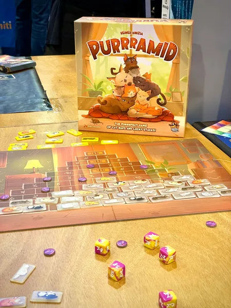 Board game 'Purramid' with dice and cards on a table
