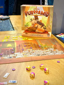 Board game 'Purramid' with dice and cards on a table
