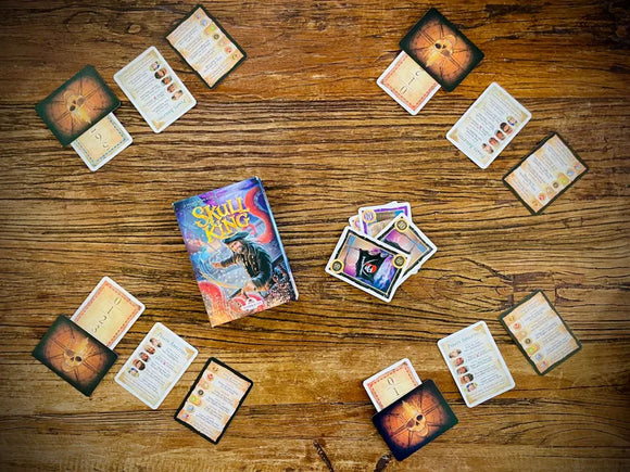 Skull King Gameplay with Cards Dealt Out to 4 Players on Wooden Tabletop Background