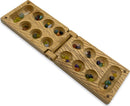 Travel Bamboo Mancala game by Project Genius displayed open, featuring a beautifully crafted bamboo board with carved seed pockets filled with colorful stones. The game showcases an intricate design that merges functionality with aesthetics, ideal for on-the-go play.