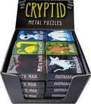 Display of Cryptid Metal Puzzles from Project Genius, featuring various cryptid designs including Moth Man, Chupacabra, Bigfoot, and others. Each puzzle comes in a colorful box with engaging artwork, all positioned neatly in a retail display.