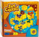 The 'Say Cheese!' game by Project Genius features a colorful box displaying cartoon mice around yellow cheese pieces. The title is prominently displayed, and it emphasizes fun, logical challenges suitable for ages 8 to 88, designed for one player. The game promises a playful and mind-boggling adventure.