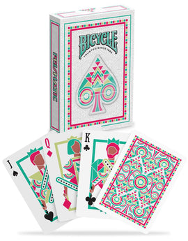 A deck of Bicycle Prismatic Playing Cards displayed with the box and three showing cards: Jack, Queen, and King. The cards feature vibrant geometric designs in pink, green, and white, showcasing unique illustrations. The box has a striking and colorful design, emphasizing the prismatic theme.