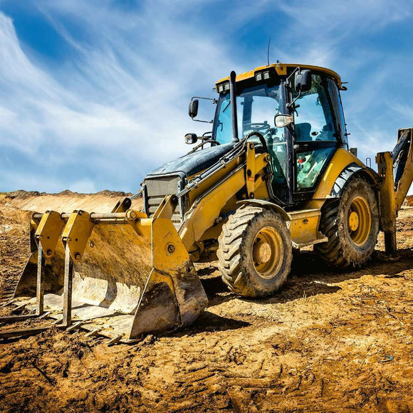 A bright yellow digger on a construction site, surrounded by a gravel and dirt landscape under a blue sky. The digger features a bucket in the front and is designed for heavy-duty excavation work, showcasing its robust build and capability.