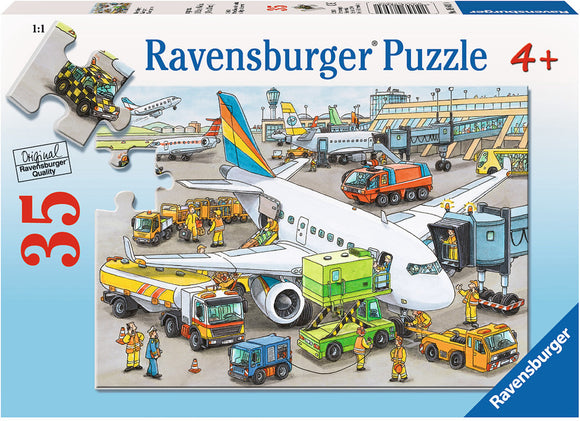 Ravensburger Busy Airport 35-piece jigsaw puzzle showing an engaging scene at an airport with various vehicles, planes, and ground crew in action. Perfect for ages 4 and up, this colorful puzzle promotes cognitive skills and imaginative play.