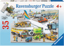 Ravensburger 35-piece jigsaw puzzle titled 'Busy Airport', depicting a busy airport scene with colorful airplanes, ground service vehicles, and staff working around the aircraft.