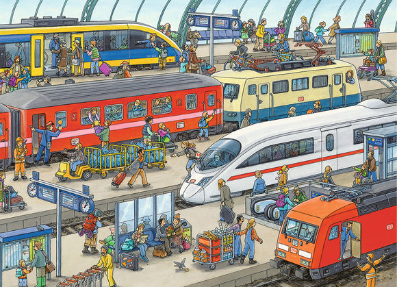 A vibrant illustration of a busy railway station featuring various trains including high-speed and regional trains. The scene is bustling with passengers of all ages, some boarding or disembarking, while others are seen interacting with their luggage or waiting on benches. Colorful characters populate the platform, surrounded by signs, schedules, and transport details. The artwork captures the lively atmosphere of train travel.