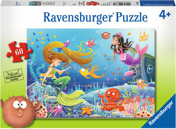 A colorful 60-piece jigsaw puzzle box featuring a vibrant underwater scene with two mermaids interacting with playful sea creatures, including fish, an octopus, and other ocean life, designed by Ravensburger for ages 4 and up.