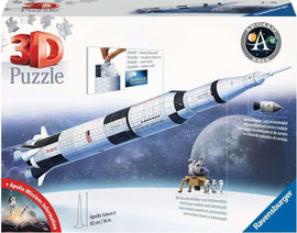 Ravensburger Apollo Saturn V Rocket 3D Puzzle box featuring detailed artwork of the iconic Saturn V rocket. The puzzle showcases 92 cm height, includes a lunar module and astronauts, and features the EasyClick technology for a stable assembly without the need for glue. The background depicts a lunar surface.