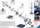 Apollo Saturn V Rocket 3D puzzle by Ravensburger. The image displays an exploded view of the intricate pieces, showcasing the rocket's components, including the command module, service module, and lunar module, ideal for ages 8 and up. The puzzle consists of 504 high-quality plastic pieces and features images of astronauts and the rocket's mission details.