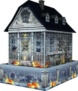 3D Haunted House Night Edition jigsaw puzzle by Ravensburger, featuring a spooky house illuminated with carved pumpkins and webs. The puzzle forms a three-dimensional haunted house with intricate details and a ghostly background, perfect for Halloween enthusiasts.