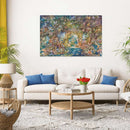 A beautifully decorated living room featuring a jigsaw puzzle titled 'The Hidden World of Fairies' made by Ravensburger. The puzzle depicts a magical fairy landscape filled with colorful fairies, lush greenery, and sparkling water scenes. The artwork is displayed on a wall above a white sofa adorned with blue cushions. A round coffee table and a bouquet of red tulips add to the cozy ambiance.