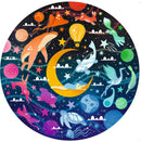 Dreams 500 piece round puzzle by Ravensburger featuring a whimsical design with floating animals, celestial elements, and a serene figure resting on a crescent moon against a starry backdrop.