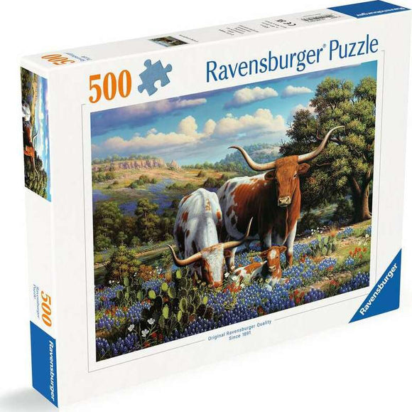 A 500-piece jigsaw puzzle titled 'Loving Longhorns' by Ravensburger. The puzzle features a scenic landscape with longhorn cattle grazing amidst colorful wildflowers and rolling hills under a blue sky.