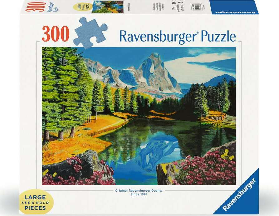 The box of the Rocky Mountain Reflections 300 jigsaw puzzle by Ravensburger, featuring a vibrant landscape scene with mountains, a blue lake, and lush green trees. The box emphasizes 'Large See & Hold Pieces' and highlights the original Ravensburger quality.