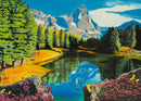 The Rocky Mountain Reflections 300 jigsaw puzzle by Ravensburger features a stunning depiction of a tranquil mountain landscape. In the foreground, vibrant pink flowers and lush green trees frame a serene lake that beautifully reflects the towering mountains and bright blue sky above. The puzzle emphasizes detail and color, inviting nature lovers to immerse themselves in this picturesque scene.