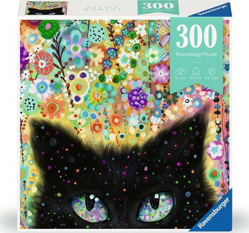 The Kaleidoscope Kitty jigsaw puzzle by Ravensburger features a vivid illustration of a black cat's face with large, colorful eyes. The background is filled with a variety of brightly colored flowers and abstract patterns, creating a vibrant and cheerful scene. The puzzle contains 300 pieces and is designed to provide a relaxing and enjoyable experience.
