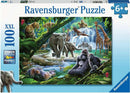 The Jungle Animals 100 pc Puzzle by Ravensburger features a vibrant scene filled with various jungle animals including elephants, gorillas, leopards, giraffes, and more, all set against a lush, green background with waterfalls and tropical plants. This jigsaw puzzle is designed for ages 6 and up and promotes fun and learning through engaging imagery.