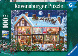 Christmas at Home Seasonal 100 jigsaw puzzle by Ravensburger. A vibrant illustration showing a cozy, festive home with decorated rooms, a Christmas tree, and Santa flying in a sleigh pulled by reindeer against a snowy backdrop. Perfect for holiday fun and family bonding.