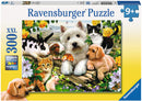 Ravensburger Happy Animal Buddies jigsaw puzzle featuring a charming scene with various cute animals including puppies, kittens, a rabbit, and guinea pigs surrounded by colorful flowers. The puzzle has 300 pieces and is designed for ages 9 and up, offering a joyful and engaging experience for animal lovers.
