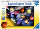 Ravensburger 300-pc jigsaw puzzle featuring a vibrant depiction of the solar system, showcasing planets like Earth, Jupiter, and Saturn amidst a colorful cosmic background with stars and galaxies.