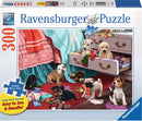 Ravensburger Mischief Makers jigsaw puzzle featuring a cozy scene with playful puppies scattered around a colorful room. A light blue blanket drapes over a couch, while a drawer is partially open revealing more puppies and colorful yarn. The vibrant colors and detailed illustrations create a playful atmosphere, suitable for family fun.