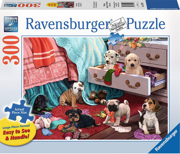 Ravensburger Mischief Makers jigsaw puzzle featuring a cozy scene with playful puppies scattered around a colorful room. A light blue blanket drapes over a couch, while a drawer is partially open revealing more puppies and colorful yarn. The vibrant colors and detailed illustrations create a playful atmosphere, suitable for family fun.