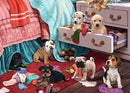 Ravensburger's Mischief Makers 300 pc large jigsaw puzzle featuring a whimsical scene with playful puppies scattered across a vibrant room. Various breeds of dogs are depicted: a Dalmatian, a yellow Labrador, a Beagle, a Pug, and others, playing with socks and toys amidst colorful bedding and a drawer full of items.