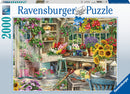 Gardener's Paradise 2000-piece jigsaw puzzle by Ravensburger featuring a vibrant garden scene. The image shows a cozy potting shed filled with colorful flowers, pots, and gardening tools, with a large window letting in sunlight.