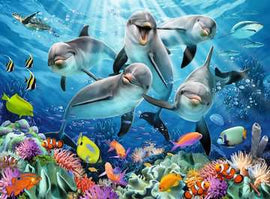 A vibrant jigsaw puzzle featuring playful dolphins swimming in a colorful coral reef. The scene includes various tropical fish and bright coral formations, set against a shimmering blue ocean backdrop with rays of sunlight penetrating the water.
