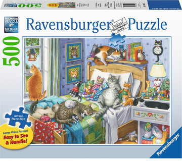 The Cat Nap jigsaw puzzle features a cozy bedroom filled with slumbering cats. A variety of cat figurines and books are arranged on the nightstand and walls, with a plush bed covered in a colorful quilt. The scene is brightened by natural light coming through the window, showcasing a whimsical and inviting atmosphere.