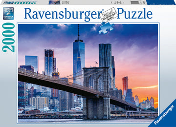 Ravensburger Skyline New York jigsaw puzzle featuring a stunning sunset view of New York City, including the Brooklyn Bridge and iconic skyscrapers, showcasing 2000 high-quality pieces for an engaging puzzle experience.
