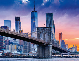 A beautifully detailed jigsaw puzzle depicting the iconic New York City skyline, featuring the Brooklyn Bridge and skyscrapers against a vibrant sunset. A Ravensburger 2000 piece puzzle designed for both challenge and enjoyment, perfect for puzzle enthusiasts.