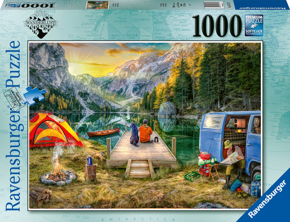 A vibrant Ravensburger puzzle box showcasing a peaceful campsite scene. Two people sit on a wooden dock by a serene lake, surrounded by majestic mountains and lush trees. A bright red and orange tent, a campfire, and a blue VW van are visible, creating a cozy outdoor atmosphere. The puzzle contains 1000 pieces and features premium quality with soft-click technology for easy assembly.