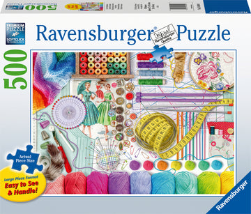 The Needlework Station 500 pc Large Format Puzzle by Ravensburger features a vibrant and detailed arrangement of sewing supplies. The image showcases colorful spools of thread, knitting needles, measuring tape, buttons, pins, and fabrics, all thoughtfully organized. The large format makes it easy to see and handle each piece, ideal for puzzle enthusiasts. SoftClick technology ensures a perfect fit for each puzzle piece.