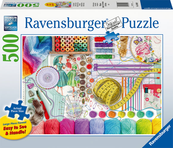 The Needlework Station 500 pc Large Format Puzzle by Ravensburger features a vibrant and detailed arrangement of sewing supplies. The image showcases colorful spools of thread, knitting needles, measuring tape, buttons, pins, and fabrics, all thoughtfully organized. The large format makes it easy to see and handle each piece, ideal for puzzle enthusiasts. SoftClick technology ensures a perfect fit for each puzzle piece.