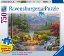 A 750-piece jigsaw puzzle titled Riverside Livingroom by Ravensburger. The image showcases a serene outdoor scene featuring two wooden chairs by a campfire, surrounded by lush greenery and mountains in the background. The puzzle's box displays the dimensions of 32x24 inches and highlights its large, easy-to-handle pieces.
