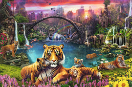 A vibrant and colorful 3000-piece jigsaw puzzle titled 'Tigers in Paradise' by Ravensburger. The artwork features a lush tropical landscape filled with tigers, elephants, flamingos, and a serene water scene. A picturesque bridge arches over the water, with a rainbow in the sky and various wildlife set against a backdrop of stunning mountains and waterfalls, all in rich, engaging colors.