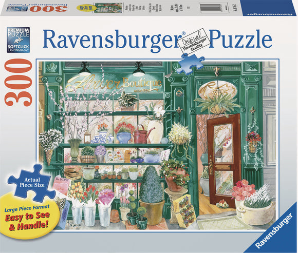 A vibrant 300-piece jigsaw puzzle by Ravensburger featuring a beautifully illustrated flower shop. The design includes shelves brimming with colorful flowers, potted plants, and decorative items, set against a charming shop entrance with a wooden door. The large format makes the pieces easy to see and handle, ideal for puzzle enthusiasts.