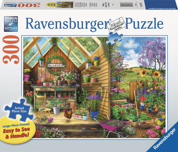 A vibrant 300-piece jigsaw puzzle featuring a charming gardener's get-away scene. The image depicts a wooden garden shed filled with colorful flower pots, tools, and a bustling garden in the background, showcasing sunflowers, a chicken, and green hills. The puzzle highlights Ravensburger's premium quality and large piece format for easy handling.