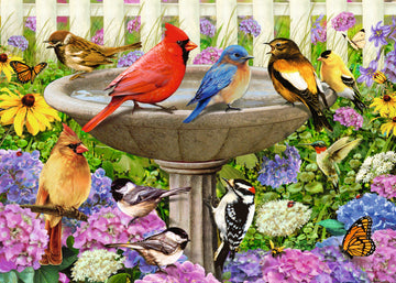 A vibrant and colorful jigsaw puzzle featuring a serene birdbath surrounded by various bird species, including a red cardinal, bluebird, and chickadees, complemented by butterflies and blooming flowers in a lush garden setting.